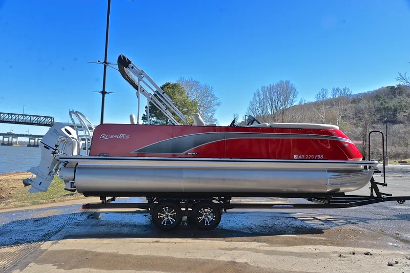 Slide: The Image of 2023 Silver Wave 2210 SW5 RLP pontoon boat on trailer by riverside. - 15