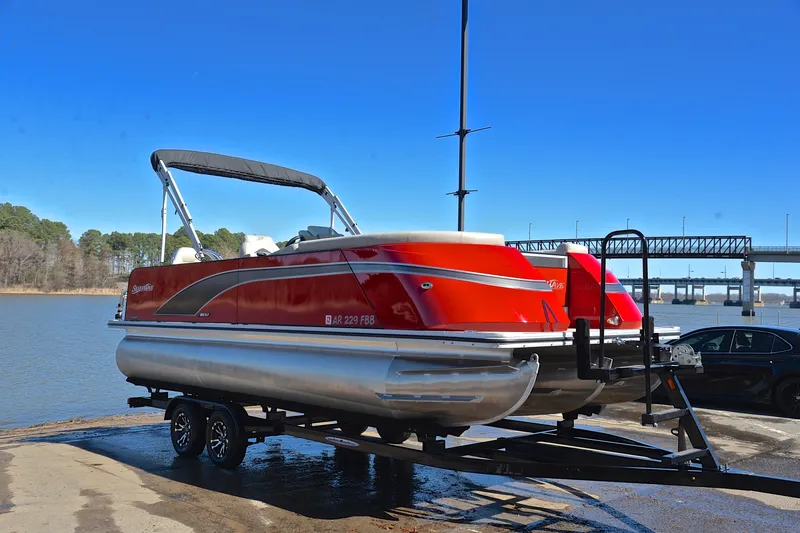 Slide: The Image of 2023 Silver Wave 2210 SW5 RLP pontoon boat on trailer by a lake. - 16