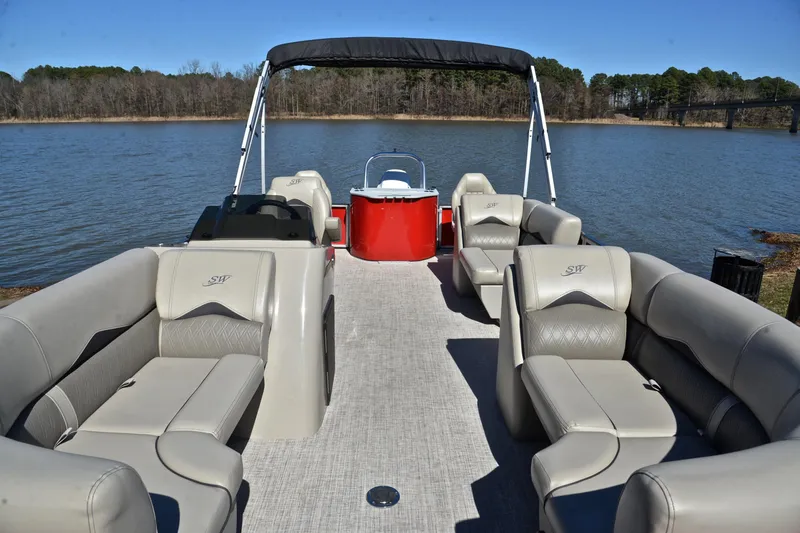 Slide: The Image of 2023 Silver Wave 2210 SW5 RLP pontoon boat with luxurious seating on a serene lake. - 20