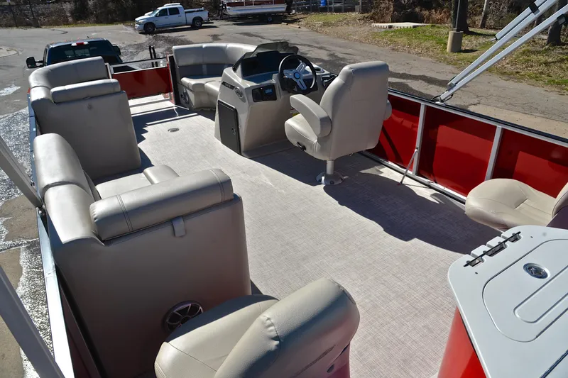 Slide: The Image of 2023 Silver Wave 2210 SW5 RLP pontoon boat interior with beige seating and red accents. - 24