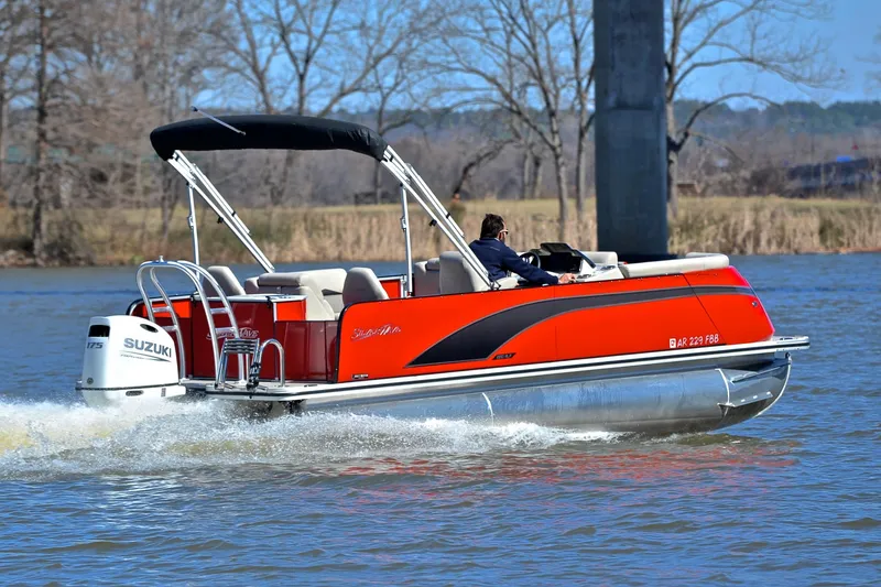 Slide: The Image of 2023 Silver Wave 2210 SW5 RLP pontoon boat cruising on a lake with Suzuki outboard motor. - 5