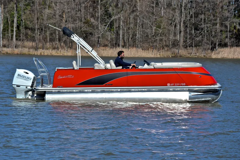 Slide: The Image of 2023 Silver Wave 2210 SW5 RLP pontoon boat cruising on a lake with Suzuki outboard motor. - 6