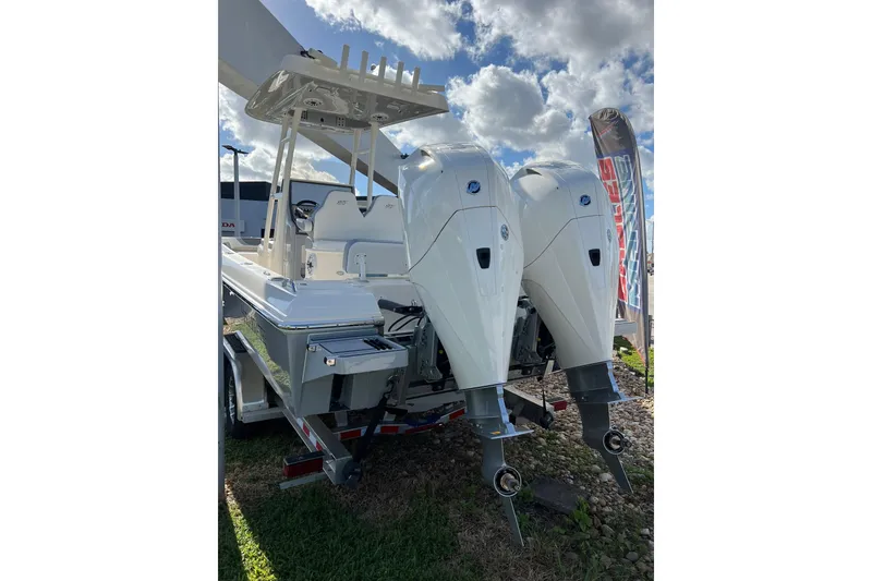 Slide: The Image of 2023 ShearWater 270 SS Carolina boat with dual outboard engines, displayed outdoors. - 10