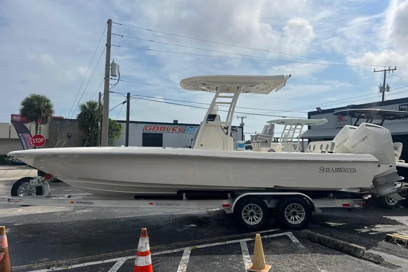 Slide: The Image of 2023 ShearWater 270 SS Carolina boat on trailer, parked outdoors. - 11