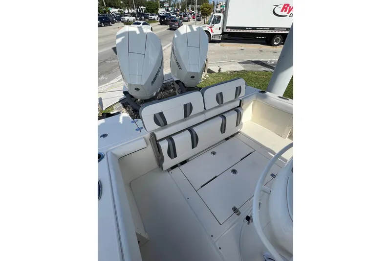 Slide: The Image of 2023 ShearWater 270 SS Carolina boat with dual Mercury engines, rear seating, and storage compartments. - 4