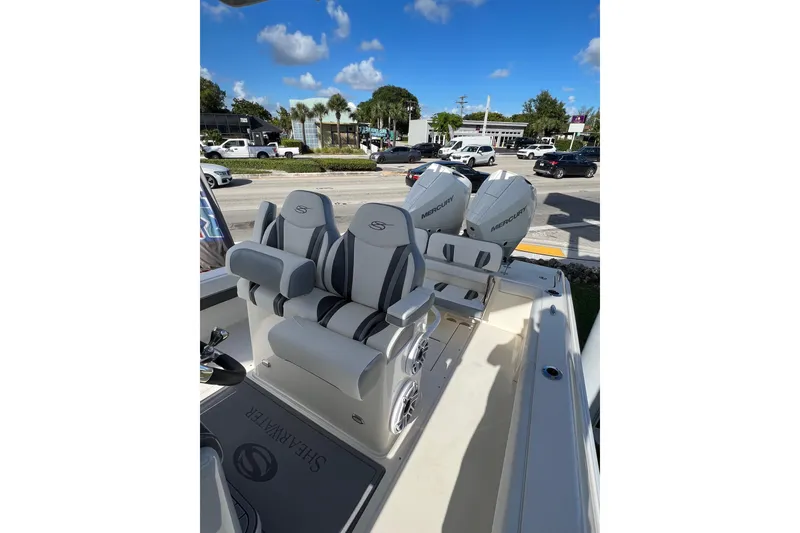 Slide: The Image of 2023 ShearWater 270 SS Carolina boat with dual Mercury engines, featuring luxurious seating. - 5