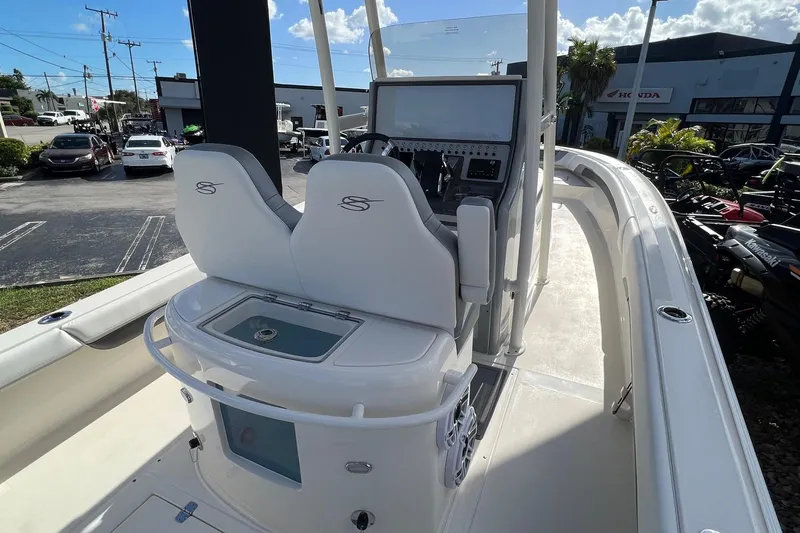 Slide: The Image of 2023 ShearWater 270 SS Carolina boat interior with dual seats and control panel. - 7
