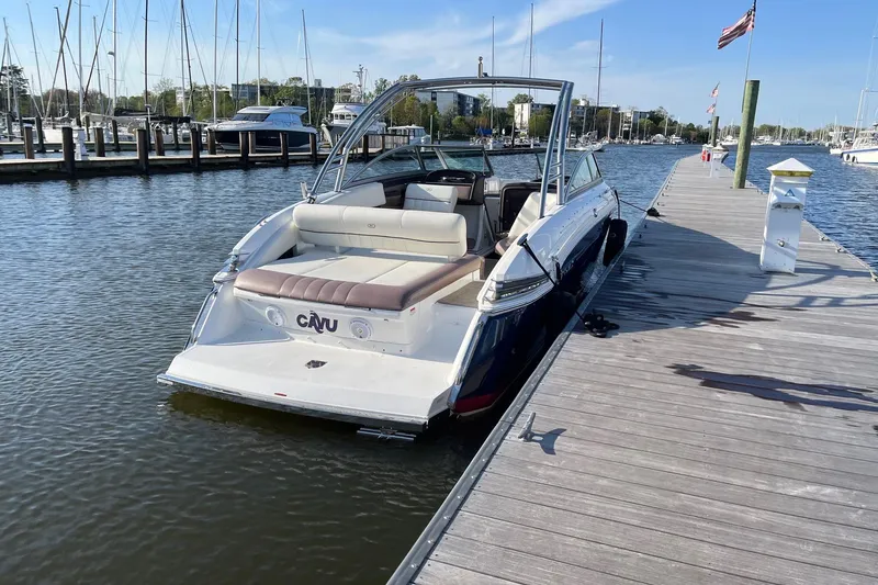 Slide: The Image of 2012 Cobalt 276 boat docked at marina with clear skies and calm water. - 5