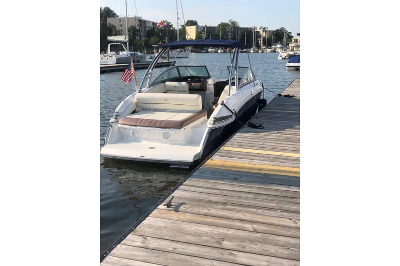 Slide: The Image of 2012 Cobalt 276 boat docked at marina, featuring sleek design and comfortable seating. - 6