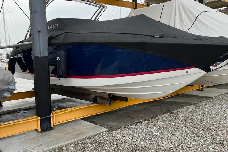 Slide: The Image of 2012 Cobalt 276 boat with cover, stored on a lift in a marina. - 9
