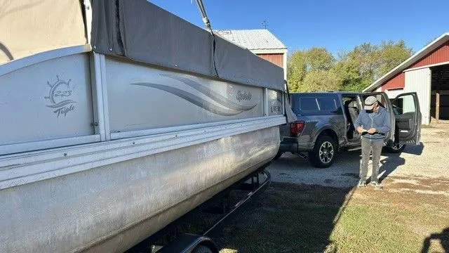 Slide: The Image of 2014 JC MFG SPIRIT 223TT FISH boat next to a car. - 8