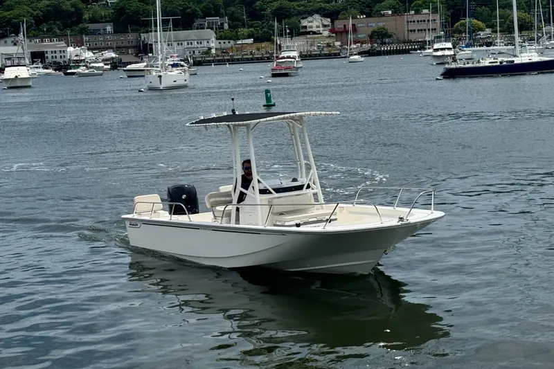 Slide: The Image of A 2026 Boston Whaler 190 Montauk cruising on calm waters in a harbor. - 1