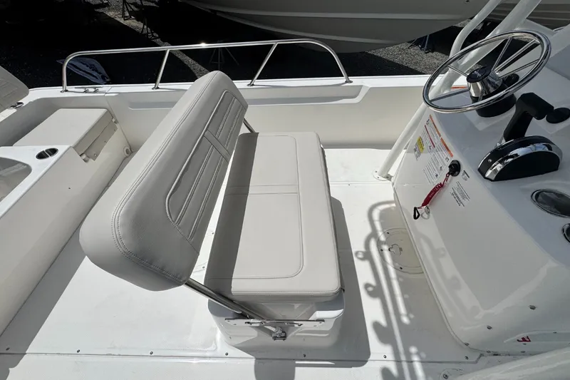 Slide: The Image of Interior view of a Boston Whaler 190 Montauk with white seating and steering console. - 10