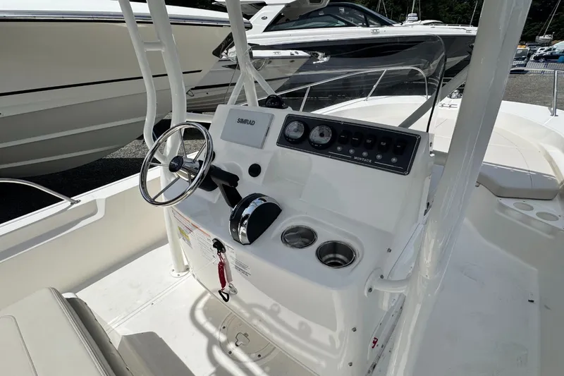Slide: The Image of The image shows the helm of a Boston Whaler 190 Montauk with steering wheel and instruments. - 11