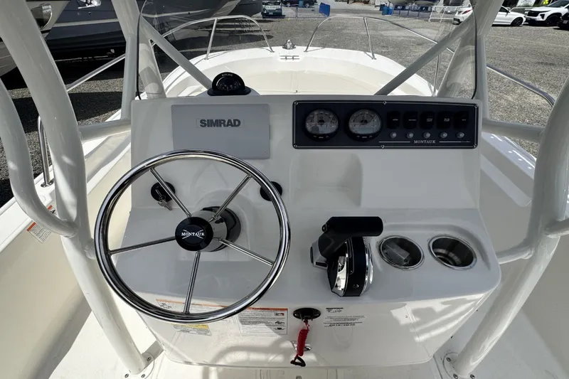 Slide: The Image of Helm of a Boston Whaler 190 Montauk with steering wheel and instruments. - 12