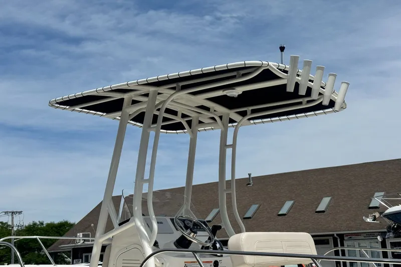 Slide: The Image of The image shows the T-top of a Boston Whaler 190 Montauk boat in front of a building. - 13