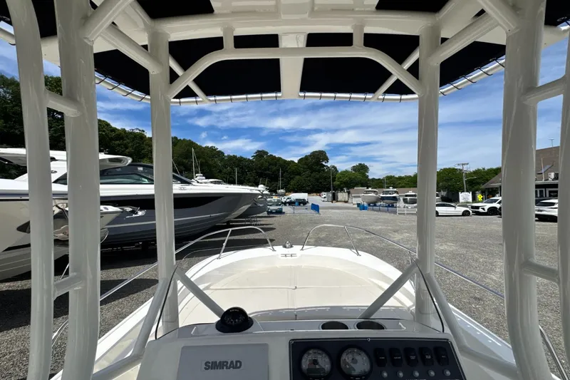 Slide: The Image of View from the helm of a Boston Whaler 190 Montauk with T-top, surrounded by other boats. - 14
