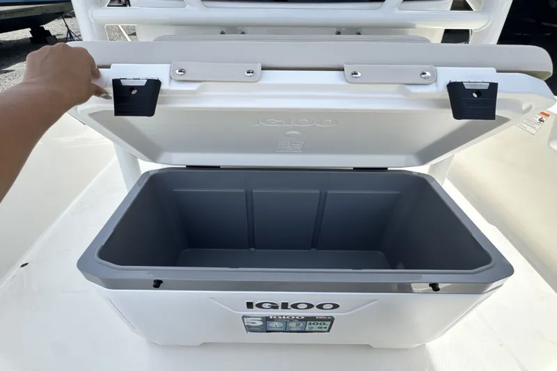 Slide: The Image of An open Igloo cooler on a boat with a hand holding the lid. - 20