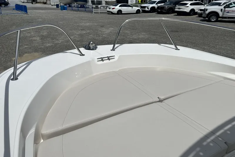 Slide: The Image of Bow of a Boston Whaler 190 Montauk with cushions, surrounded by cars in a parking lot. - 22