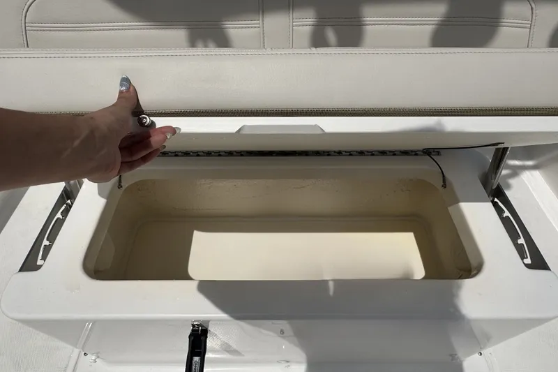 Slide: The Image of An open storage compartment on a boat with cushioned seating. - 9