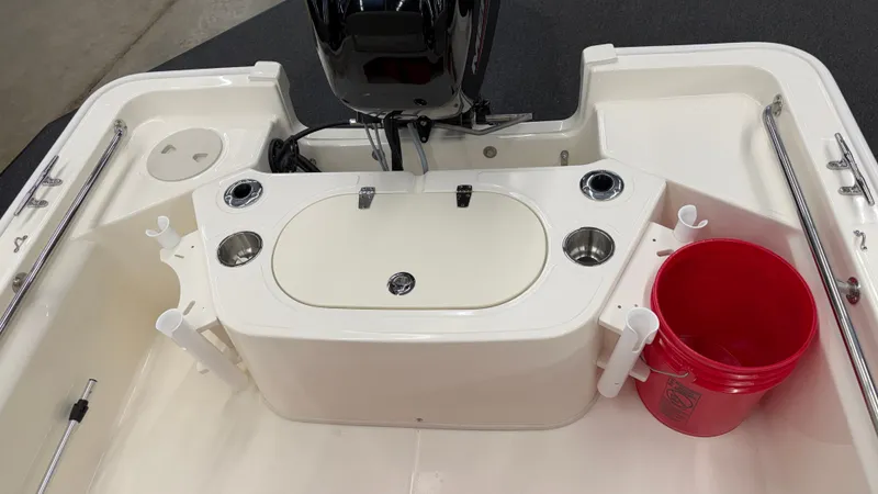 Slide: The Image of The image shows the stern of a Boston Whaler 150 Montauk with an outboard motor and rod holders. - 11