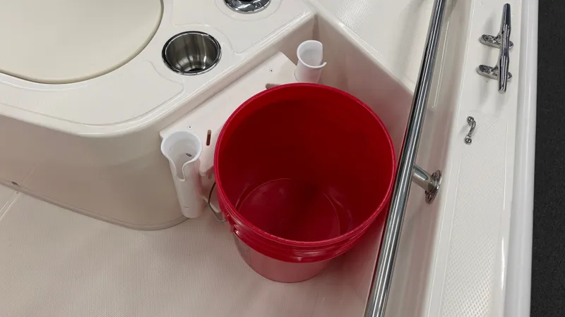 Slide: The Image of A red bucket sits on the deck of a Boston Whaler 150 Montauk boat. - 12