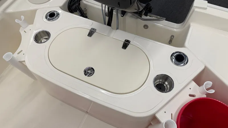 Slide: The Image of The image shows the cockpit of a Boston Whaler 150 Montauk with rod holders and cup holders. - 13
