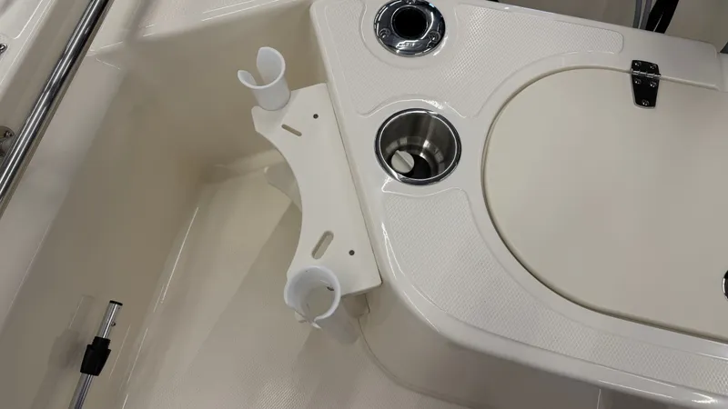 Slide: The Image of Close-up of a Boston Whaler 150 Montauk cockpit with cup holders and stainless steel fittings. - 15