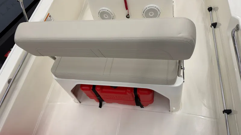 Slide: The Image of The 2026 Boston Whaler 150 Montauk features a cushioned bench seat with storage space underneath. - 17