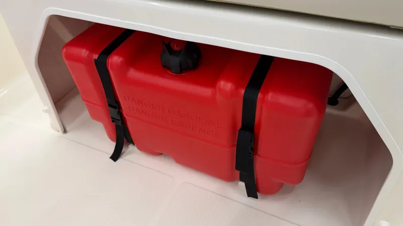 Slide: The Image of A red gasoline tank is secured under a white seat on a boat. - 18