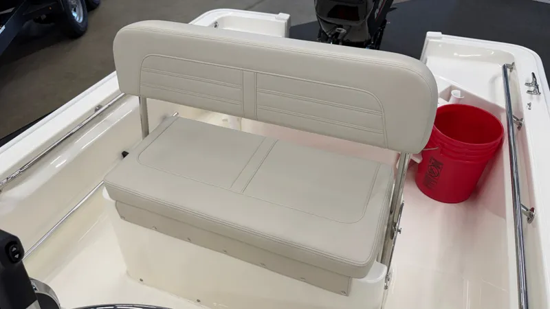 Slide: The Image of The 2026 Boston Whaler 150 Montauk features a cushioned bench seat and a red bucket. - 20