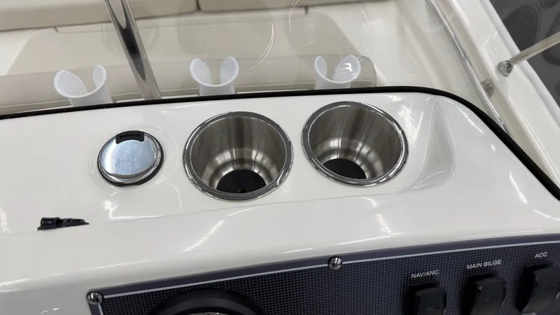 Slide: The Image of Close-up of a boat console area with cup holders and switches. - 30