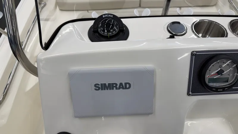 Slide: The Image of The dashboard of a Boston Whaler 150 Montauk with Simrad display and compass. - 31
