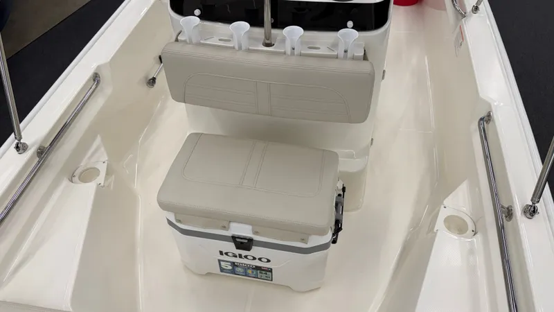 Slide: The Image of Interior view of a Boston Whaler 150 Montauk with bench seating and a cooler. - 33