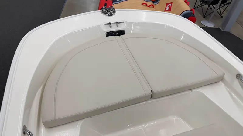 Slide: The Image of The 2026 Boston Whaler 150 Montauk features a cushioned bow deck with beige cushions. - 36
