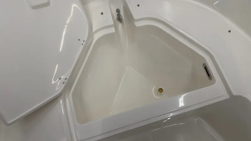 Slide: The Image of An open storage compartment on a boat with a white interior. - 38