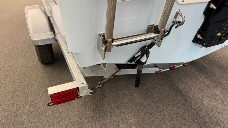 Slide: The Image of A 2026 Boston Whaler 150 Montauk on a trailer. The rear and ladder are visible. - 40