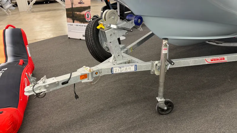 Slide: The Image of A Boston Whaler 150 Montauk on a trailer in a showroom. - 43