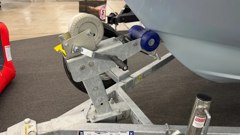 Slide: The Image of Close-up of a boat trailer with a winch and blue rollers. - 46