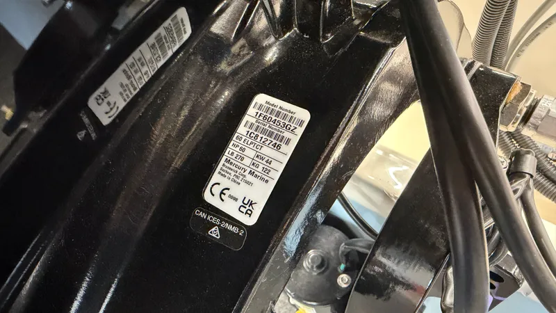 Slide: The Image of Close-up of a boat engine with technical stickers and cables. - 49