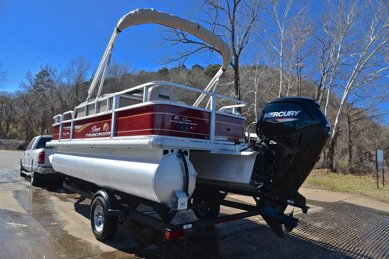 Slide: The Image of 2024 Sun Tracker Bass Buggy 18 DLX pontoon boat with Mercury engine on trailer. - 12