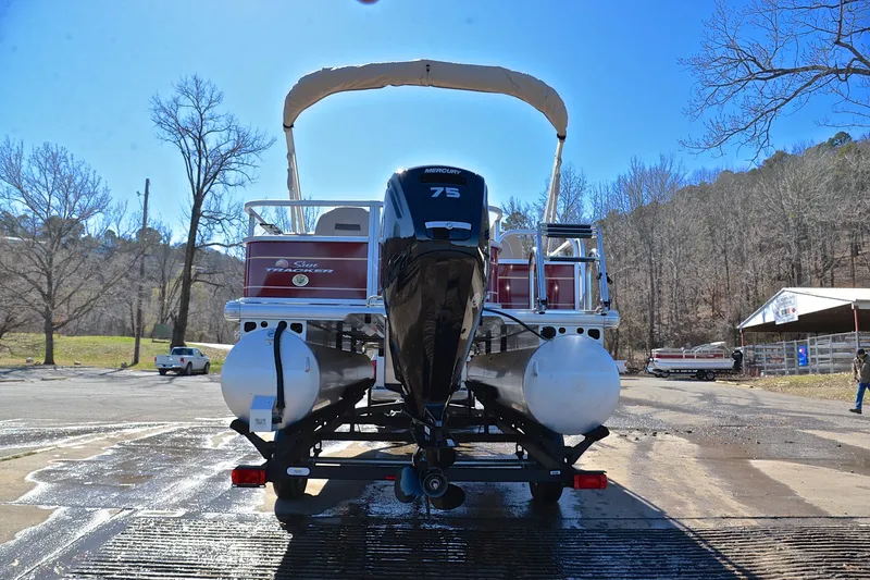 Slide: The Image of 2024 Sun Tracker Bass Buggy 18 DLX pontoon boat with Mercury 75 engine on trailer. - 13