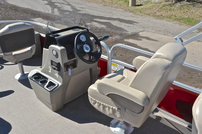 Slide: The Image of 2024 Sun Tracker Bass Buggy 18 DLX boat interior with steering console and seating. - 24
