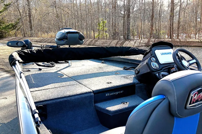 Slide: The Image of 2025 Ranger RT188P fishing boat with Lowrance electronics, parked near a wooded area. - 10