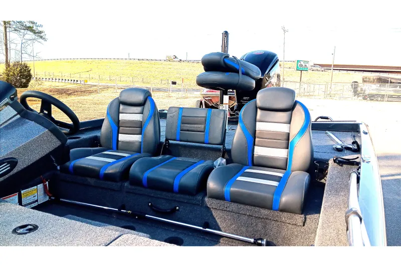 Slide: The Image of 2025 Ranger RT188P boat interior with blue and gray seating, steering wheel, and console. - 12