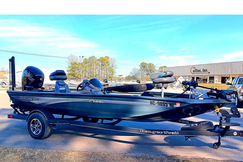 Slide: The Image of 2025 Ranger RT188P fishing boat on trailer, parked outdoors near dealership. - 4