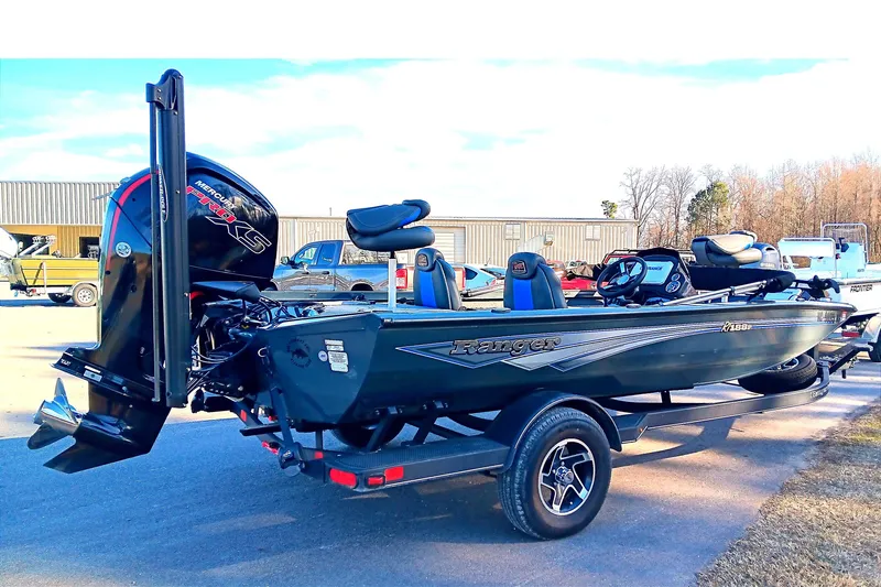 Slide: The Image of 2025 Ranger RT188P boat with Mercury engine on trailer, parked outdoors. - 6