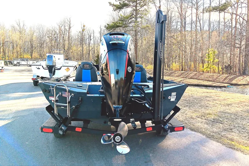 Slide: The Image of 2025 Ranger RT188P boat with powerful outboard motor on a trailer, parked outdoors. - 7