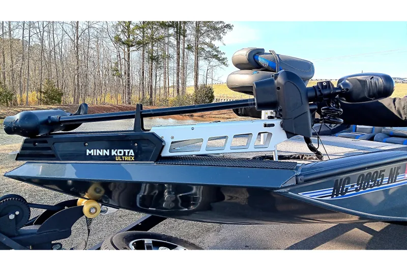 Slide: The Image of 2025 Ranger RT188P boat with Minn Kota Ultrex trolling motor in a wooded area. - 8
