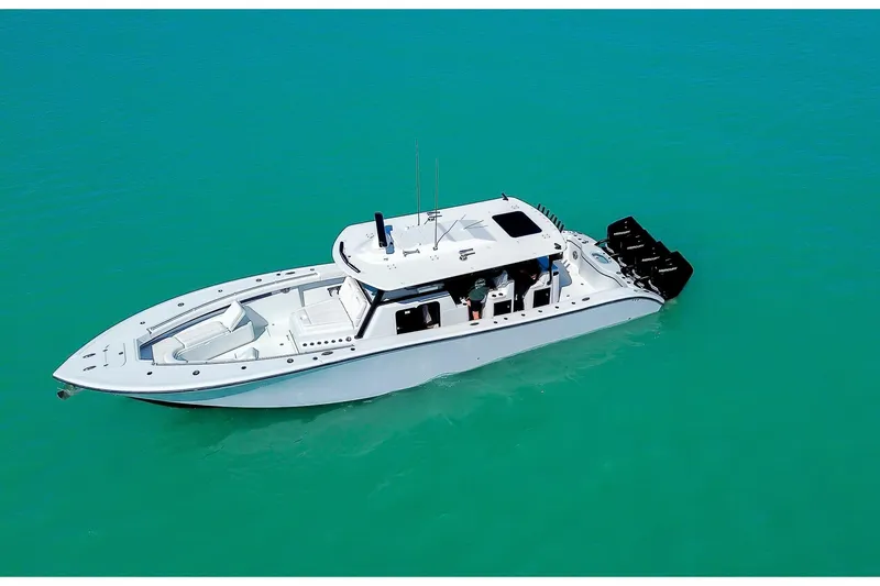 Slide: The Image of 2024 Yellowfin 42 Offshore boat on turquoise water, aerial view. - 10